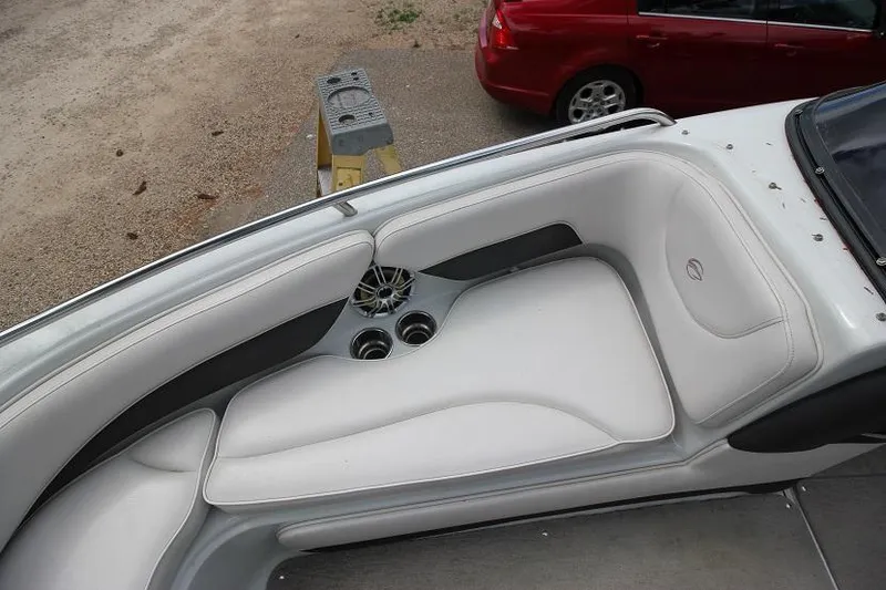 Slide: The Image of 2015 Crownline 21 SS boat interior with white seating and cup holders. - 12