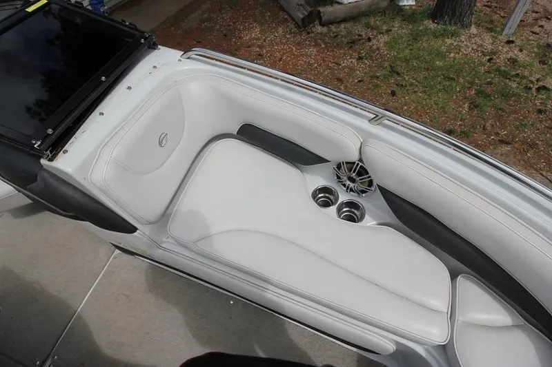 Slide: The Image of 2015 Crownline 21 SS boat interior with white seating and cup holders. - 13