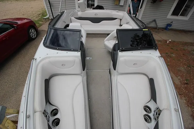 Slide: The Image of 2015 Crownline 21 SS boat interior with white seating and cup holders. - 14