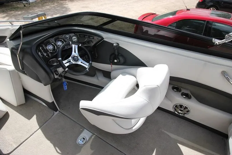 Slide: The Image of 2015 Crownline 21 SS boat cockpit with steering wheel and captain's chair. - 6