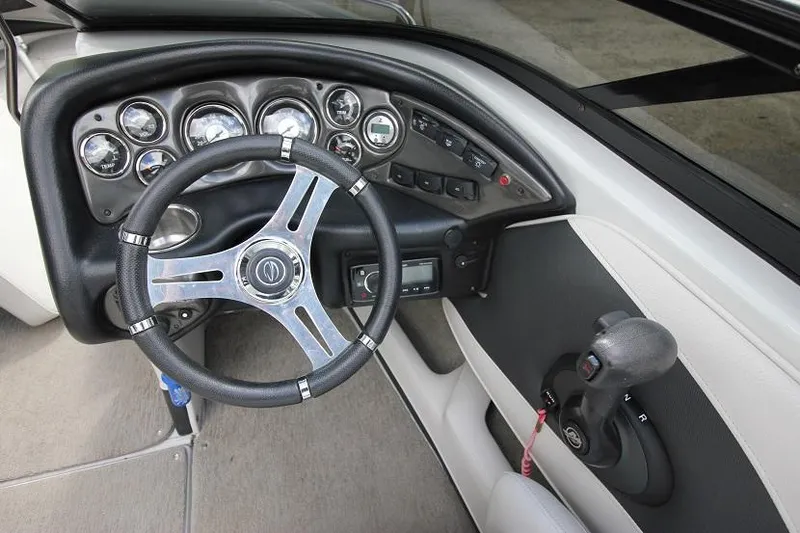 Slide: The Image of 2015 Crownline 21 SS boat dashboard with steering wheel and control panel. - 7