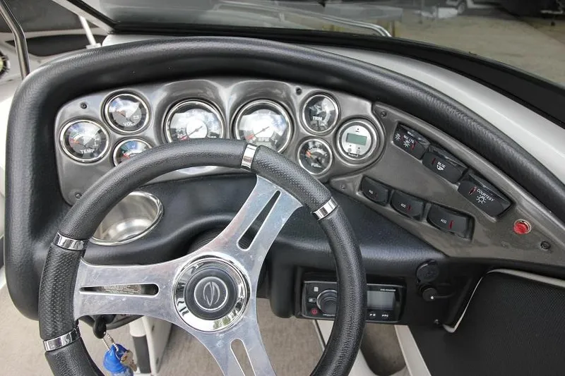 Slide: The Image of 2015 Crownline 21 SS boat dashboard with steering wheel and instrument panel. - 8