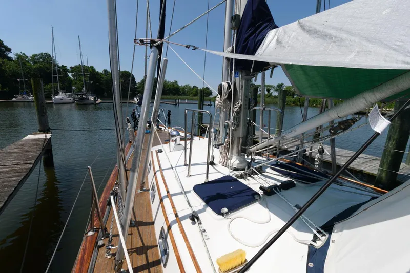 Slide: The Image of 1988 Tayana 52 sailboat docked at a marina. - 10