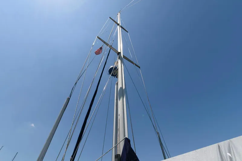 Slide: The Image of Mast of 1988 Tayana 52 sailboat against clear blue sky. - 15