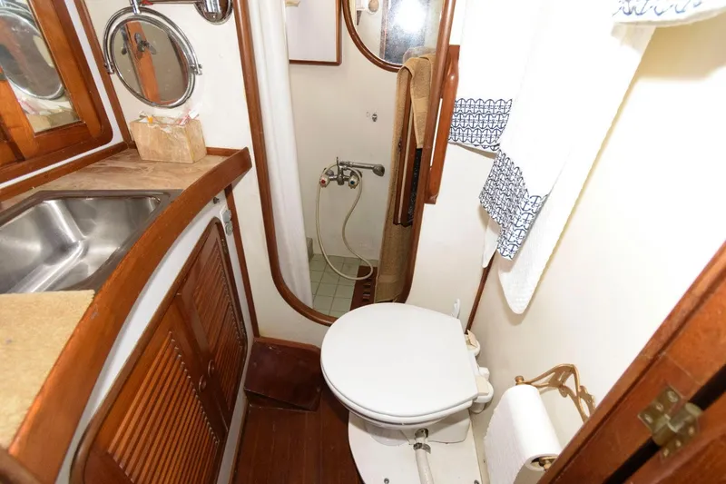 Slide: The Image of 1988 Tayana 52 yacht bathroom with sink, toilet, and shower. - 35