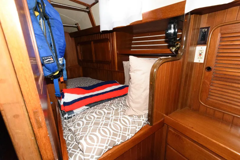 Slide: The Image of Cozy cabin bed in 1988 Tayana 52 sailboat with wooden interior. - 36