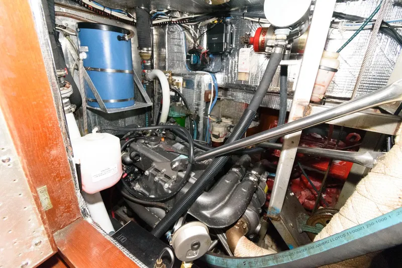 Slide: The Image of Engine room of a 1988 Tayana 52 sailboat with various mechanical components. - 41