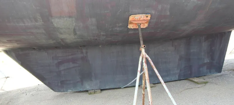 Slide: The Image of Bottom view of 1988 Tayana 52 sailboat hull supported by a metal stand. - 44