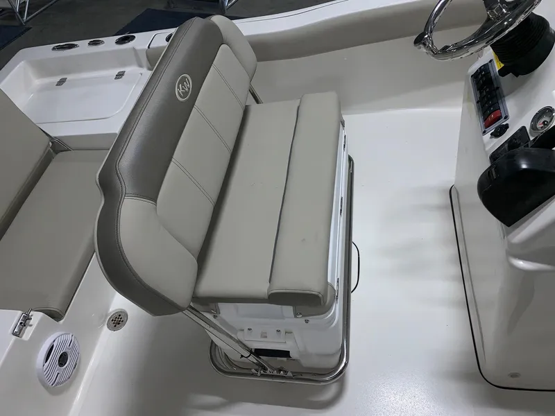 Slide: The Image of 2024 Key West 179 FS boat interior with cushioned seating and steering console. - 10