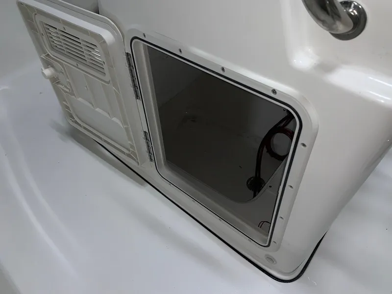 Slide: The Image of 2024 Key West 179 FS storage compartment with open hatch. - 12