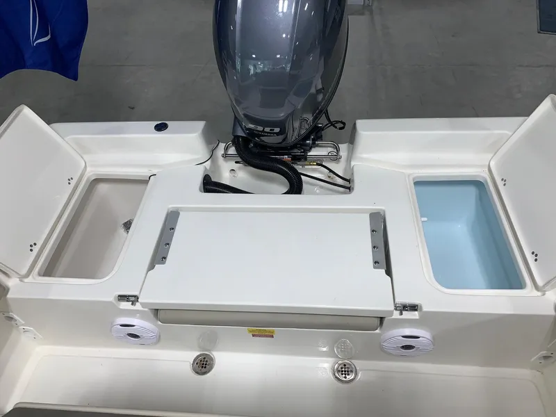 Slide: The Image of 2024 Key West 179 FS boat stern with storage compartments and outboard motor. - 14