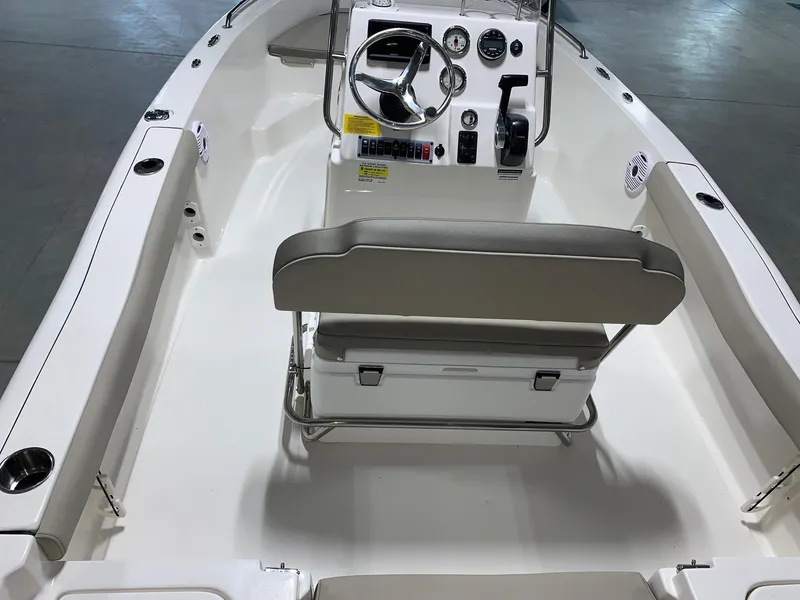 Slide: The Image of 2024 Key West 179 FS boat interior with steering console and cushioned seating. - 15