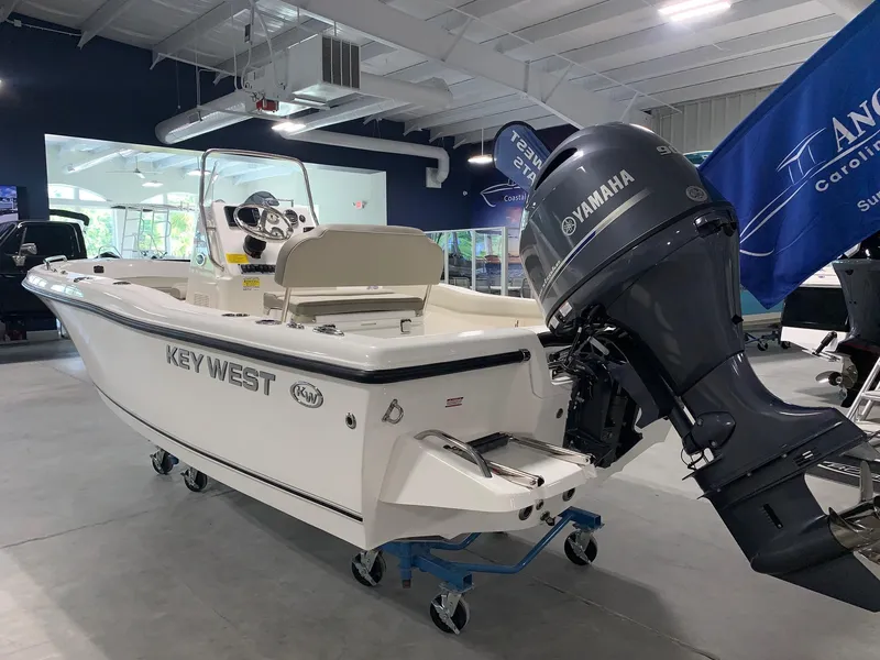 Slide: The Image of 2024 Key West 179 FS boat with Yamaha outboard motor in showroom. - 2