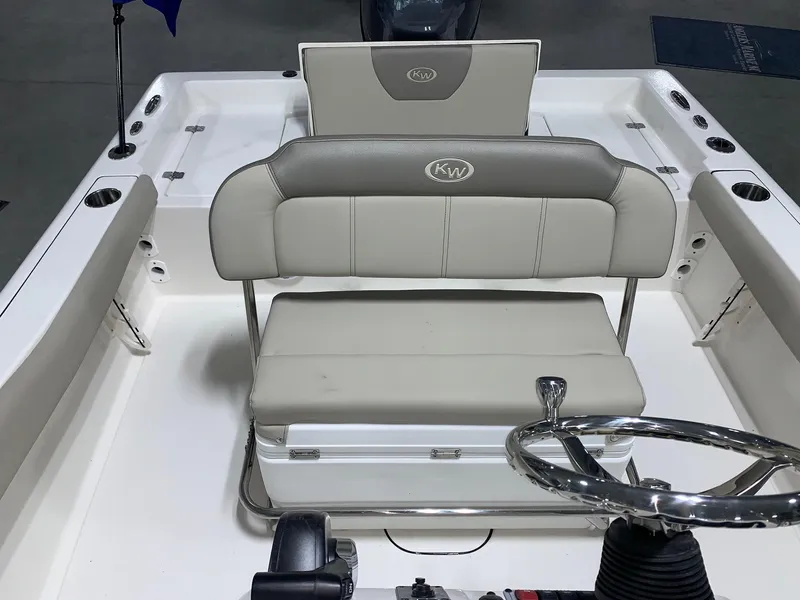 Slide: The Image of 2024 Key West 179 FS boat interior with cushioned seating and steering wheel. - 9