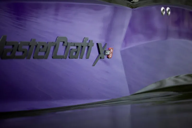 Slide: The Image of 2023 MasterCraft XStar S Piranha boat in purple. - 6