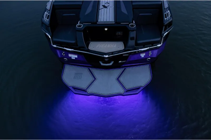 Slide: The Image of 2023 MasterCraft XStar S Piranha boat with purple underwater lights. - 7