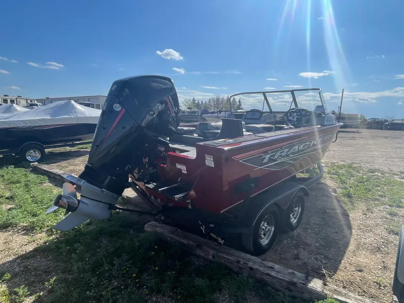 Slide: The Image of 2019 Tracker Targa 19 Combo boat with outboard motor in a sunny outdoor setting. - 3