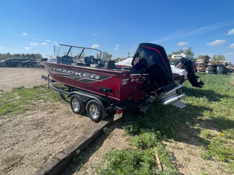 Slide: The Image of 2019 Tracker Targa 19 Combo boat on a trailer in an outdoor setting. - 4