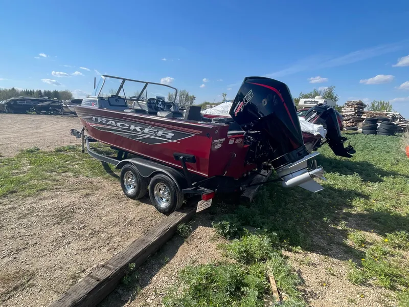 Slide: The Image of 2019 Tracker Targa 19 Combo boat on a trailer in an outdoor setting. - 5