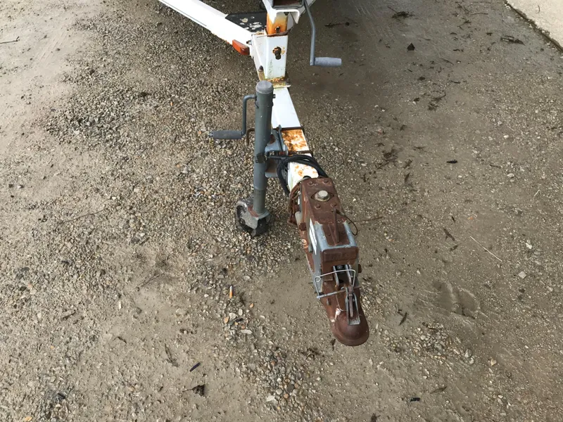 Slide: The Image of Rusty trailer hitch of a 1997 Bayliner 2050 boat on gravel. - 10