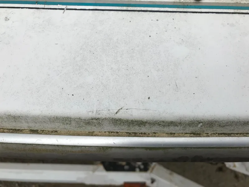Slide: The Image of Close-up of a 1997 Bayliner 2050 boat showing wear and dirt on the surface. - 15
