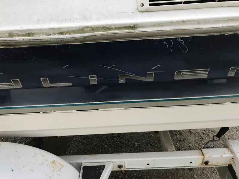 Slide: The Image of 1997 Bayliner 2050 boat with visible wear and scratches on the hull. - 17