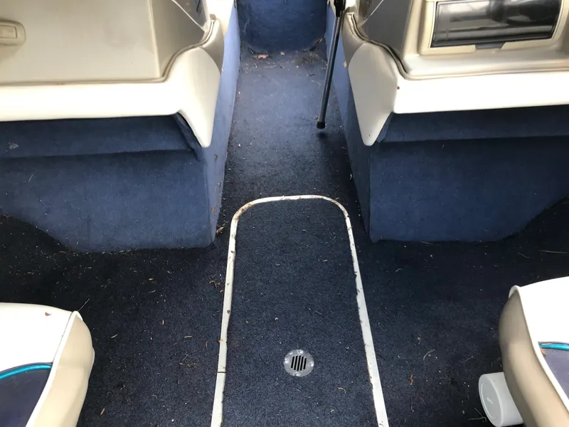 Slide: The Image of 1997 Bayliner 2050 boat interior with blue carpet and white seats. - 20