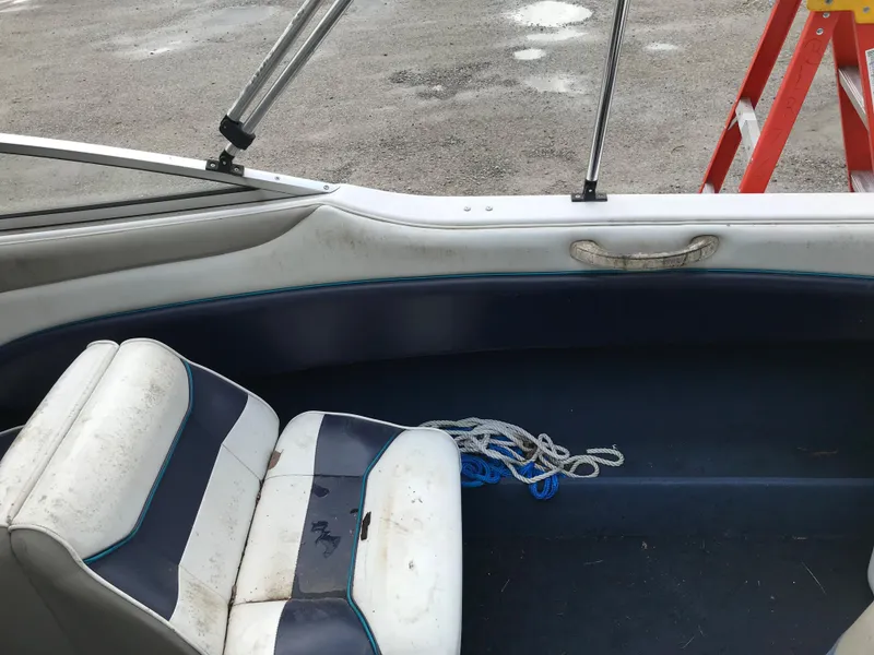 Slide: The Image of 1997 Bayliner 2050 boat interior with white and blue seating. - 21