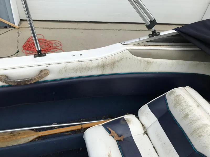 Slide: The Image of 1997 Bayliner 2050 boat interior with worn seats and dirty surfaces. - 22
