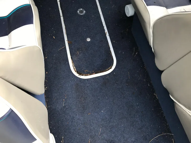 Slide: The Image of 1997 Bayliner 2050 boat interior with blue carpet and beige seats. - 29