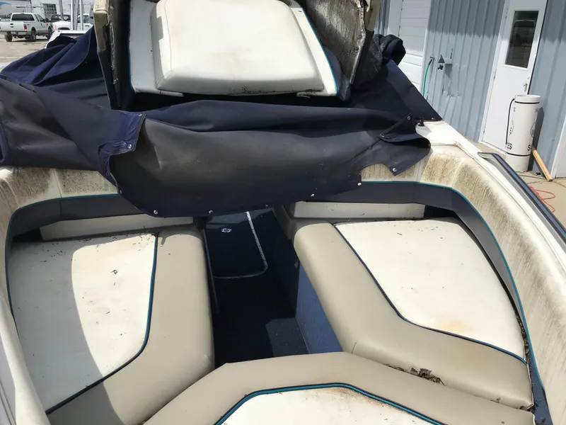 Slide: The Image of 1997 Bayliner 2050 boat interior with white and blue seating. - 30