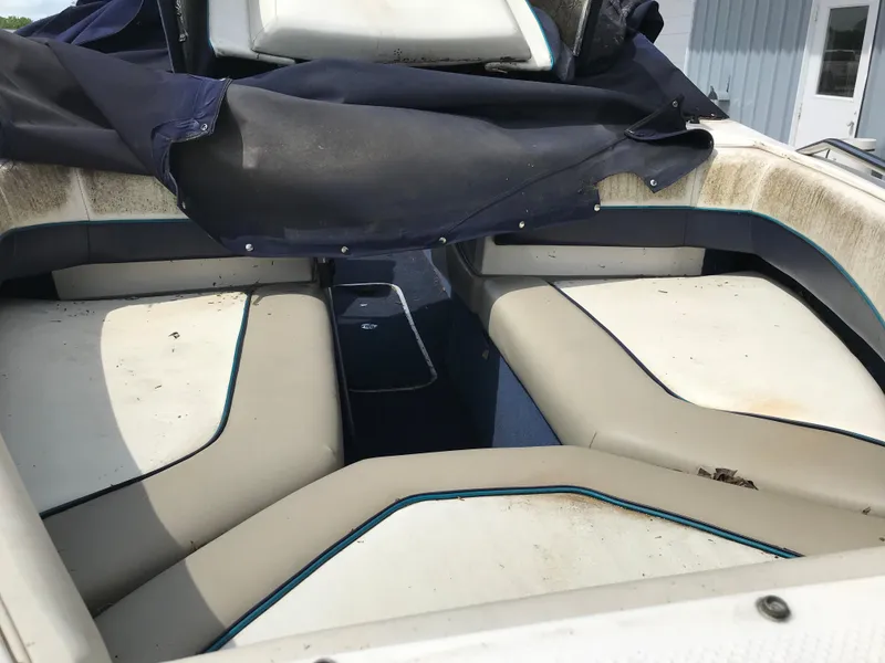 Slide: The Image of 1997 Bayliner 2050 boat interior with white and blue seating. - 31