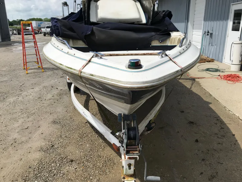 Slide: The Image of 1997 Bayliner 2050 boat on trailer, covered and parked outdoors. - 32