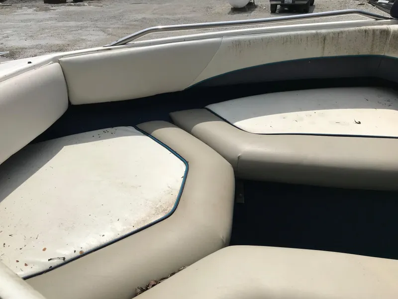 Slide: The Image of 1997 Bayliner 2050 boat interior with worn, dirty seating. - 33