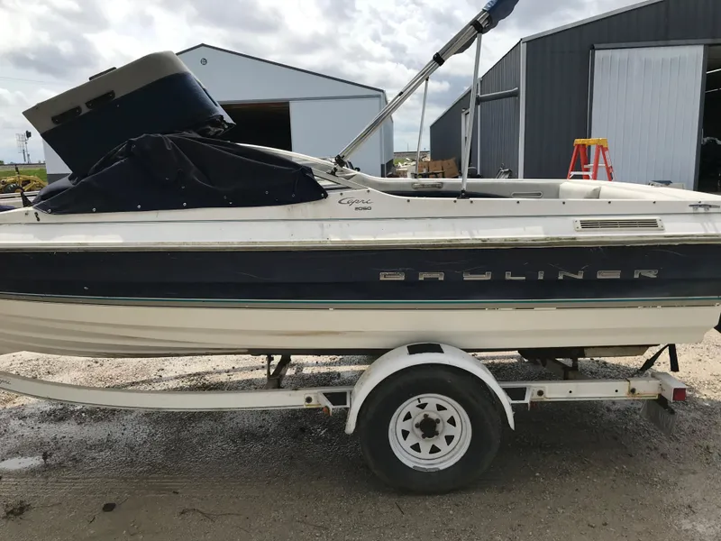 Slide: The Image of 1997 Bayliner 2050 boat on trailer near storage buildings. - 35