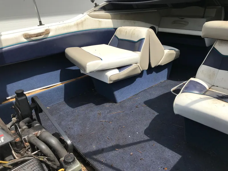 Slide: The Image of 1997 Bayliner 2050 boat interior with blue carpet and white seats. - 37
