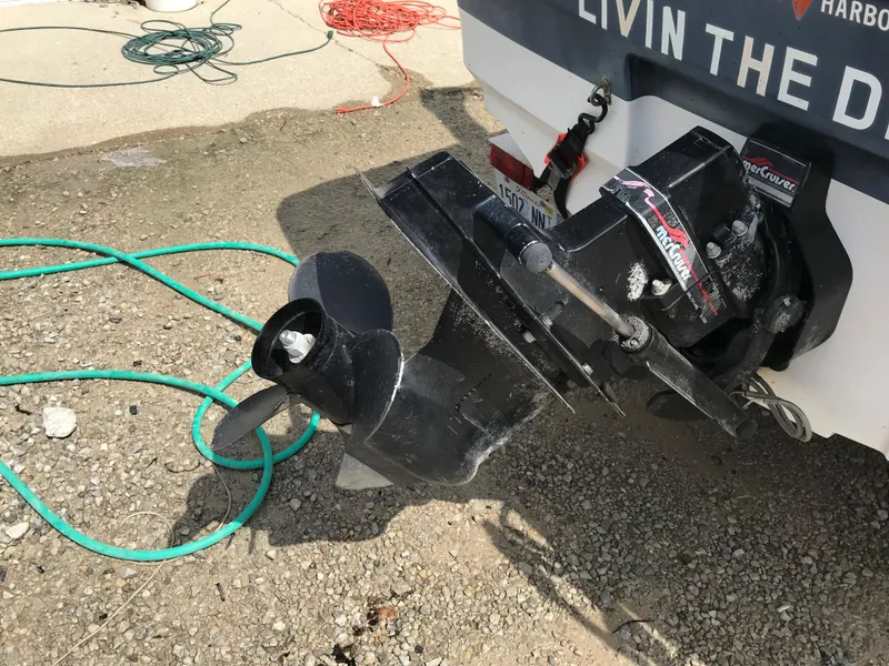 Slide: The Image of 1997 Bayliner 2050 boat propeller and stern drive on gravel. - 39