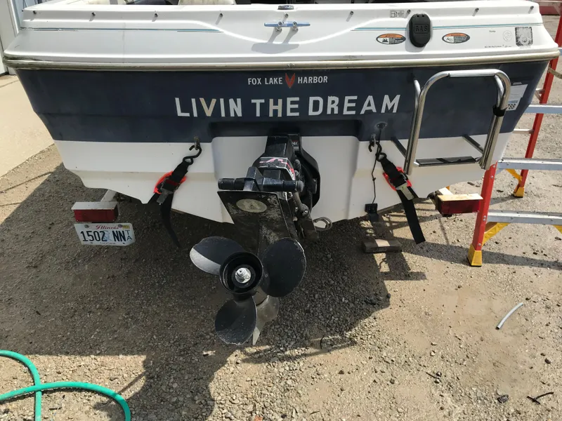 Slide: The Image of 1997 Bayliner 2050 boat stern with Livin the Dream text at Fox Lake Harbor. - 41