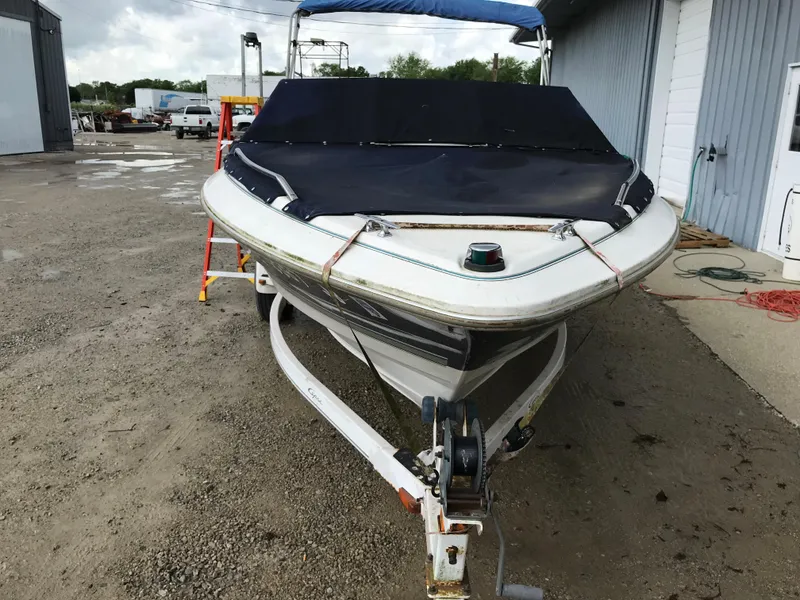Slide: The Image of 1997 Bayliner 2050 boat on trailer, covered and parked outdoors. - 9