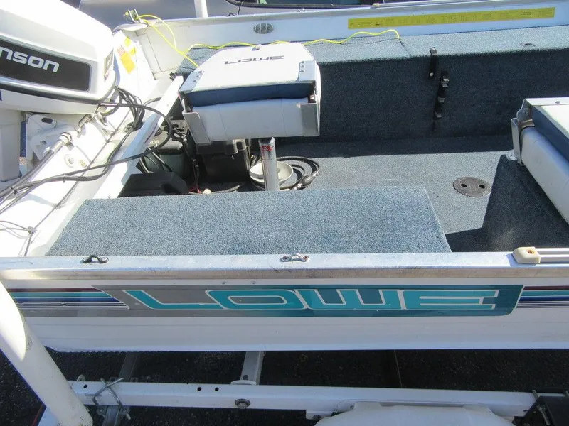 Slide: The Image of 1994 Lowe 1605 SC boat interior with Johnson motor. - 4