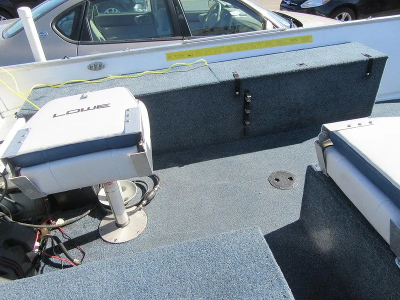 Slide: The Image of 1994 Lowe 1605 SC boat interior with seating and storage compartments. - 5