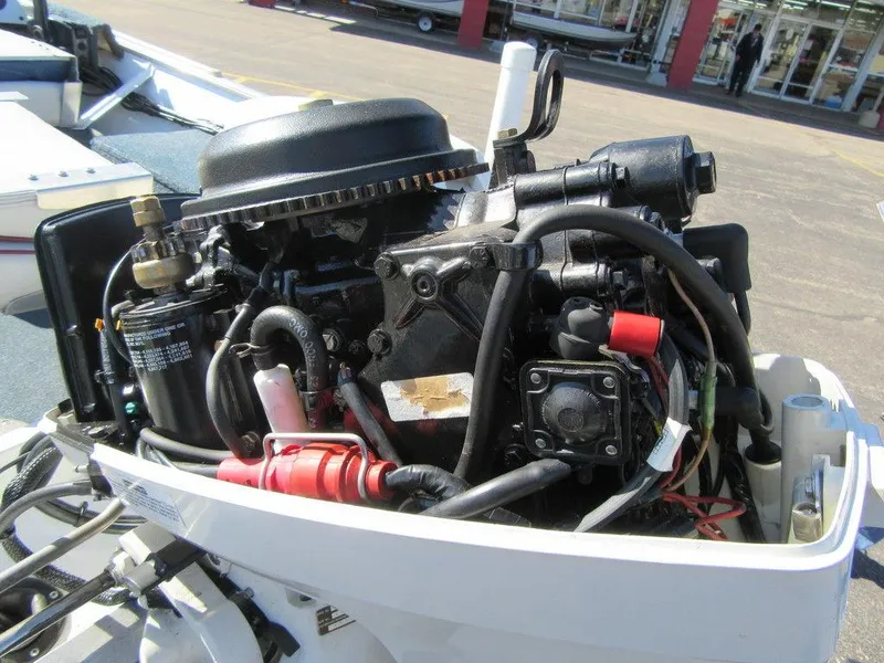 Slide: The Image of Close-up of a 1994 Lowe 1605 SC boat engine in a marina. - 9