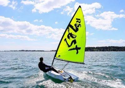 The Image of 2024 RS Zest sailboat on open water under a sunny sky. - 0