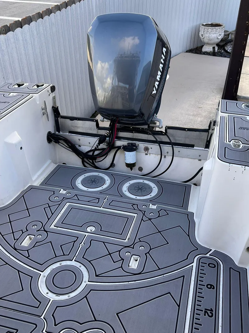 Slide: The Image of 1990 Mako 24' boat with Yamaha outboard motor and custom deck flooring. - 6