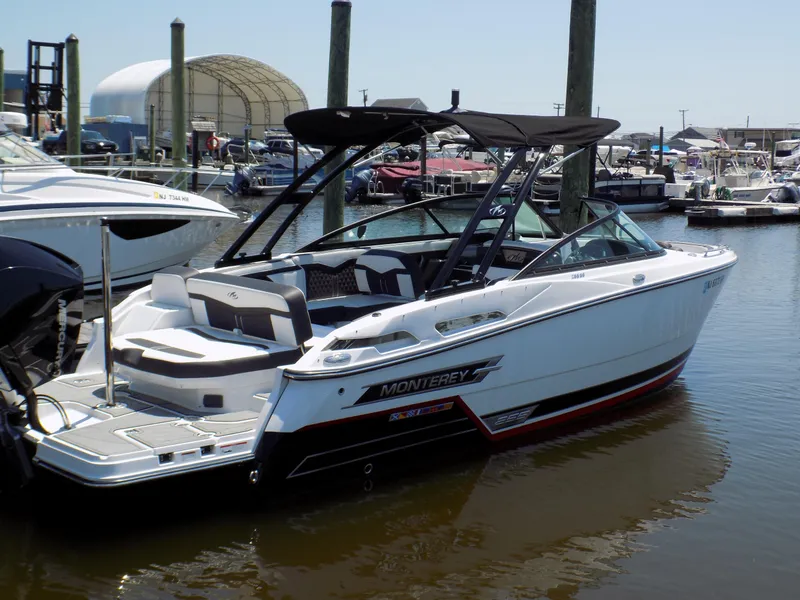 Slide: The Image of 2021 Monterey 255 Super Sport boat docked at marina, featuring sleek design and modern amenities. - 0
