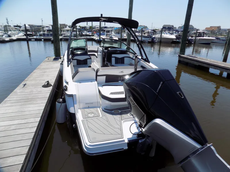 Slide: The Image of 2021 Monterey 255 Super Sport boat docked at marina, rear view with outboard motor. - 3