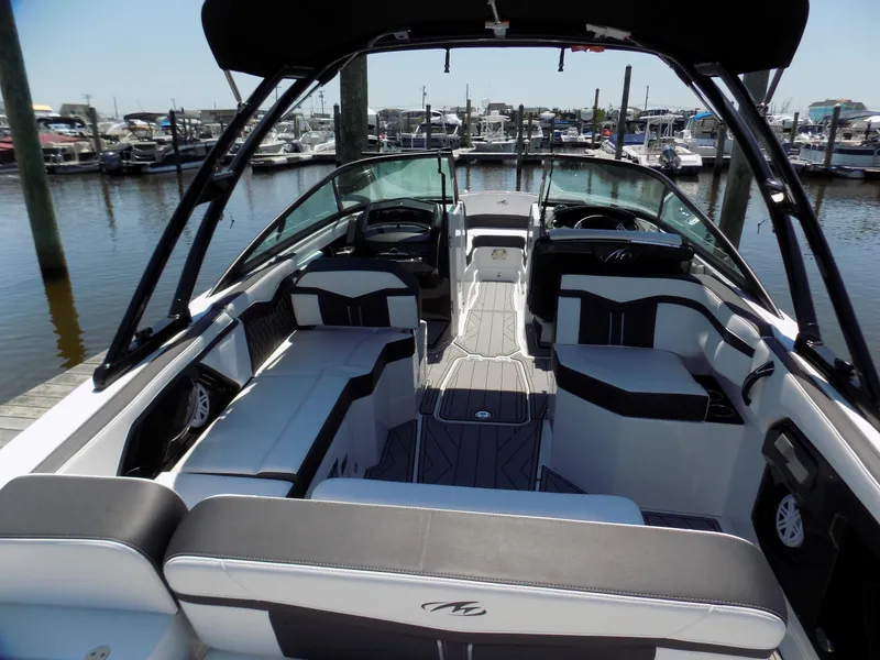 Slide: The Image of 2021 Monterey 255 Super Sport boat interior at marina, featuring sleek seating and modern design. - 4