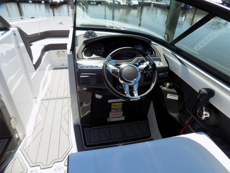 Slide: The Image of 2021 Monterey 255 Super Sport boat interior with steering wheel and dashboard. - 6