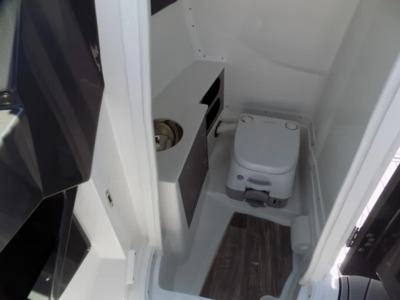 Slide: The Image of 2021 Monterey 255 Super Sport boat interior with compact toilet and sink. - 9
