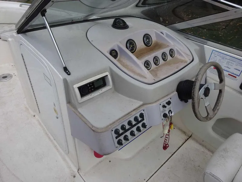 Slide: The Image of 1996 Wellcraft 2400S ECLIPSE boat dashboard with steering wheel and control panel. - 12